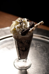 Chocolate milkshake with whipped cream and chocolate wafer sticks