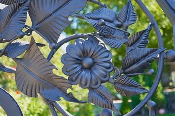 wrought flowers with leaves, elements of metal forged floral details close-up