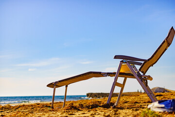 Deckchair on sandy beach