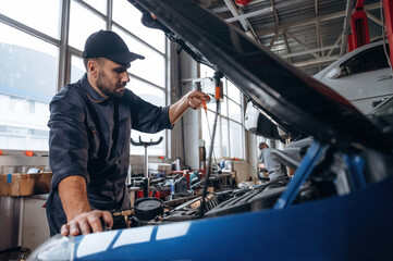 Transport is being repaired. Mechanic working in a car service station