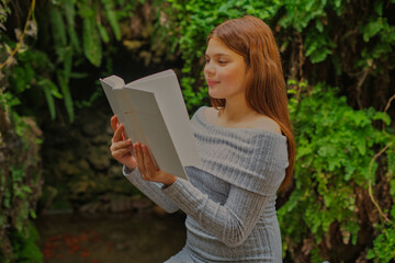 Obraz premium Twin sisters enjoying reading in a peaceful garden setting