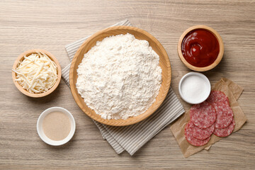Making calzone pizza. Different ingredients on wooden table, flat lay