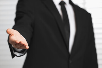 Fototapeta premium Man offering helping hand on light background, closeup