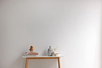 Stylish console table with decor near white wall indoors. Space for text