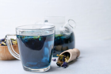 Delicious butterfly pea flower tea on white table