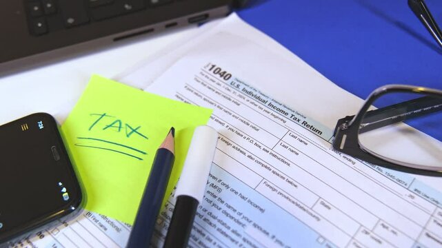 Accountant preparing tax form 1040 for tax season 2025