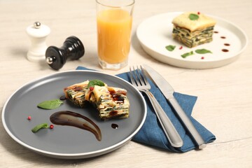 Pieces of tasty spinach lasagna served on wooden table, closeup