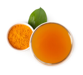 Aromatic turmeric tea in glass, green leaf and powder isolated on white, top view