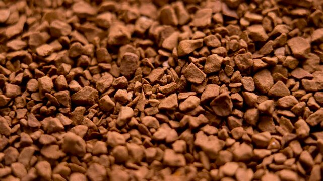 Aromatic granules of instant coffee. Morning drink soluble ingredient. Macro shot. Rotation