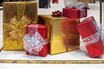 beautiful gold and red gift boxes tied with ribbons and huge bows. Boxing Day. Waiting for the...