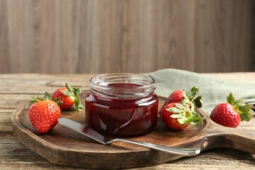 Delicious strawberry sauce and fresh berries on wooden table. Space for text