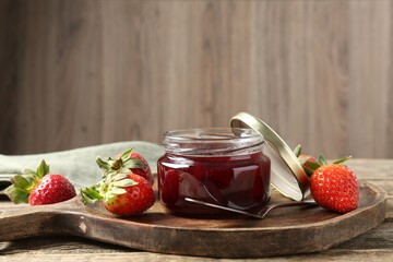 Delicious strawberry sauce and fresh berries on wooden table. Space for text