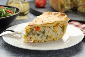 Piece of delicious fresh homemade pie served on gray textured table, closeup