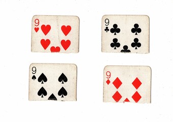 Torn quarters of old playing cards showing the same value on a white background.