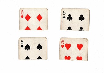 Torn quarters of old playing cards of the same value.