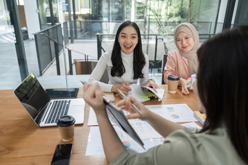 Engaged women discussing financial strategies in an office