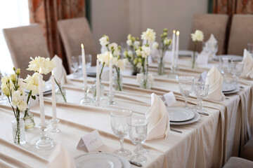 decorated festive table with plates and tablecloth in a restaurant	