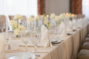 decorated festive table with plates and tablecloth in a restaurant	