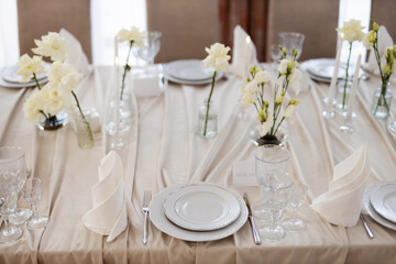decorated festive table with plates and tablecloth in a restaurant