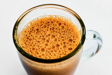 Coffee or hot chocolate drink in glass cup, closeup.