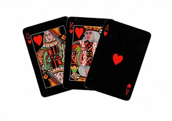 Vintage black playing cards showing a run of three in the same suit.