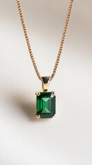 Emerald Pendant: A captivating close-up showcases a stunning gold necklace with a vibrant green emerald pendant, radiating elegance and allure.