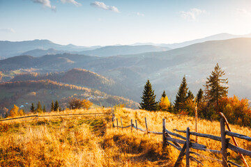 Incredible panorama of autumn hills with remote villages and sunny spectacular valleys. Carpathian...