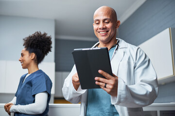 Smiling Medical Professionals Using a Tablet Technology in a Modern Clinic Environment
