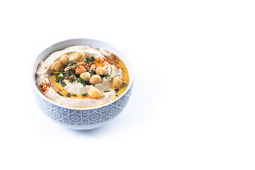 Chickpea hummus with olive oil, parsley and paprika in bowl isolated on white background. Copy space