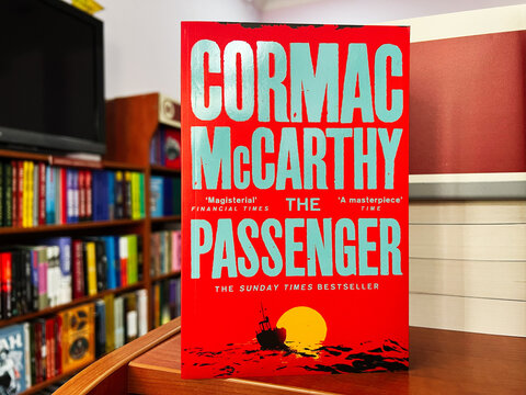 Cormac McCarthy's The Passenger displayed on a shelf in a bookstore