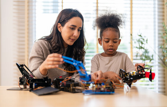 Portrait happy teacher help school children student having fun activity learn training play building toy STEM, education, science, engineering, programming, coding, robot technology class at school