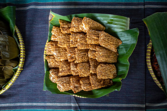 Close up of Tempe Garit Goreng (fried soybean cake) on banana leaf. Indonesian traditional food