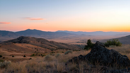 Naklejka premium Sunset Over Rolling Hills and Distant Mountains