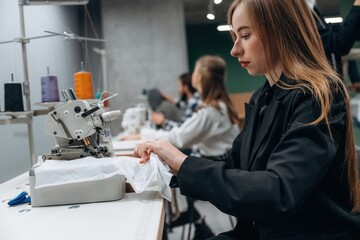 Obraz premium Job of clothing production. People are working by the sewing machines indoors