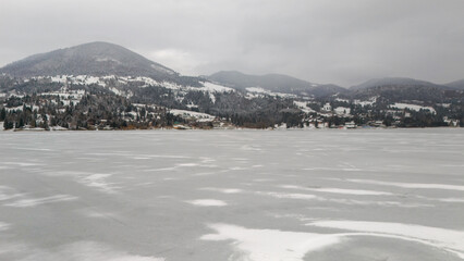 winter landscape with mountains, lake and snow