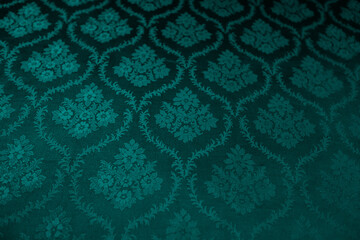 Closeup of turquoise victorian vintage textured textile wall