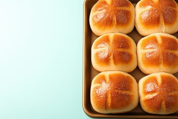 Soft, golden-brown dinner rolls arranged neatly on baking tray,