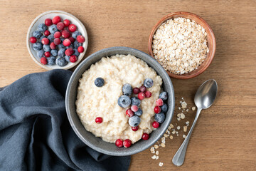 Bowl of cooked oatmeal porridge with berries
