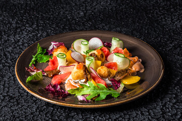 delicious and colorful smoked salmon salad with a mix of leaves, cheeses, cold cuts accompanied by sweet potato chips