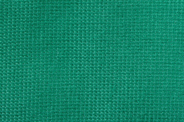 Green woven fabric texture with tight grid pattern and detailed fibers. Bright green fabric texture, abstract pattern background. Natural fabric texture background with pattern for banner and design