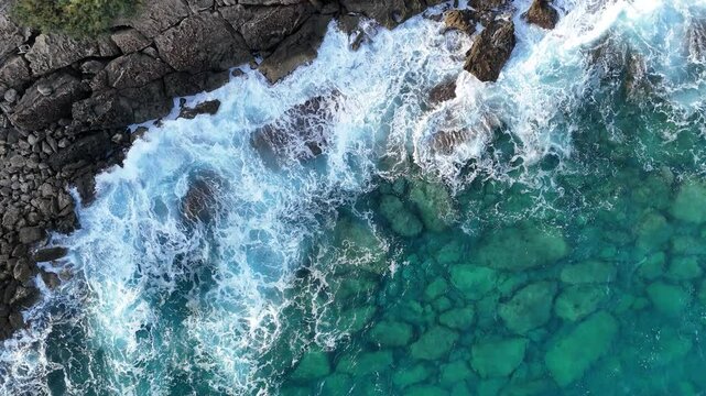 Drone footage of crystal waters of Torre Lapillo and waves crashing on rocks