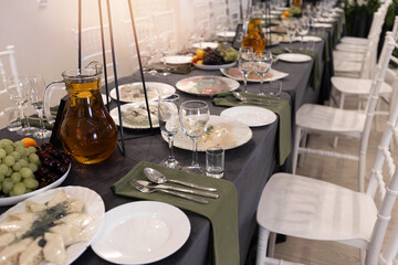 decorated round table with tablecloth in restaurant at banquet	