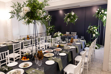 decorated round table with tablecloth in restaurant at banquet	