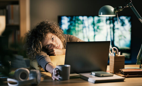 Exhausted woman working late at night