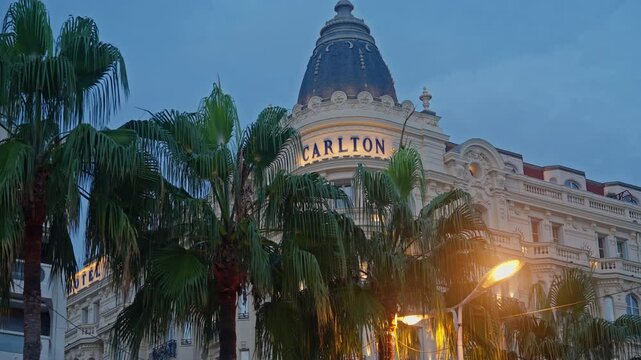 Cannes, France. The illuminated facade of the Carlton Hotel on the Cannes waterfront in the evening