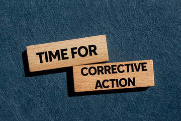 Time for corrective action message written on wooden blocks on gray background. Conceptual time for...