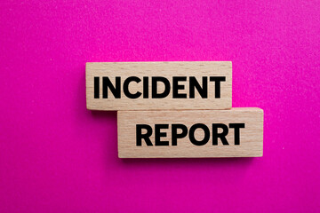 Incident report message written on wooden blocks on pink background. Conceptual incident report symbol. Copy space.
