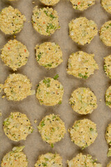 A top-down shot of raw soy patties arranged on parchment paper, ready for baking, showcasing their textured surface and visible ingredients