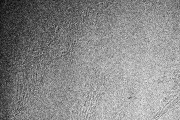 Closeup of rough sand in black and white.