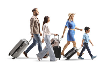Full length profile shot of a family with a teenage girl and boy walking with suitcases © Ljupco Smokovski